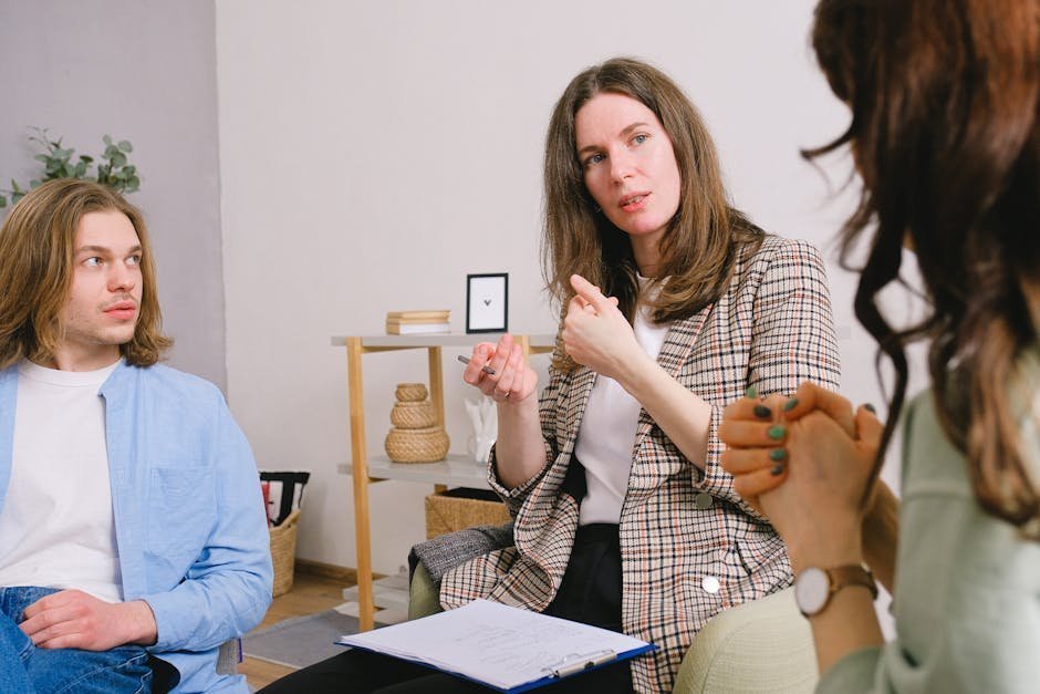 Polyamorous triad in therapy session with affirming non-monogamy therapist