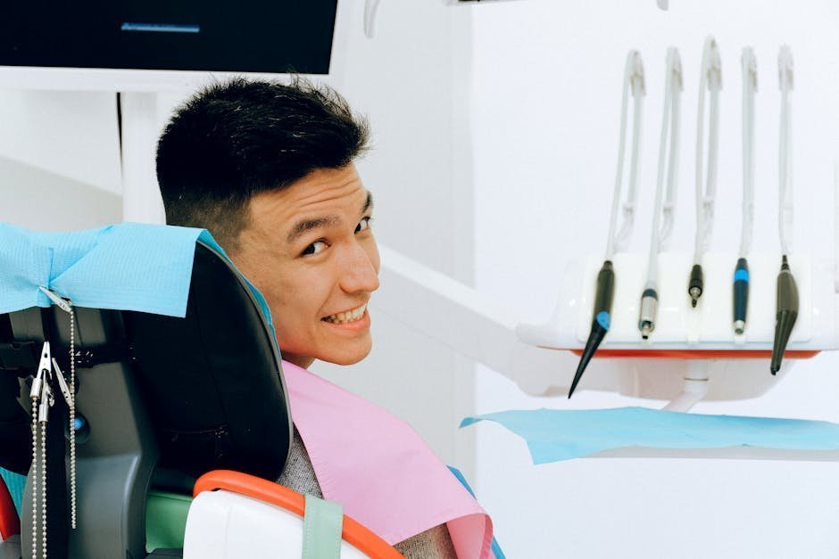 Patient seated under a NeuroStar TMS coil while a certified technician adjusts the figure-8 magnetic coil over the dorsolateral prefrontal cortex